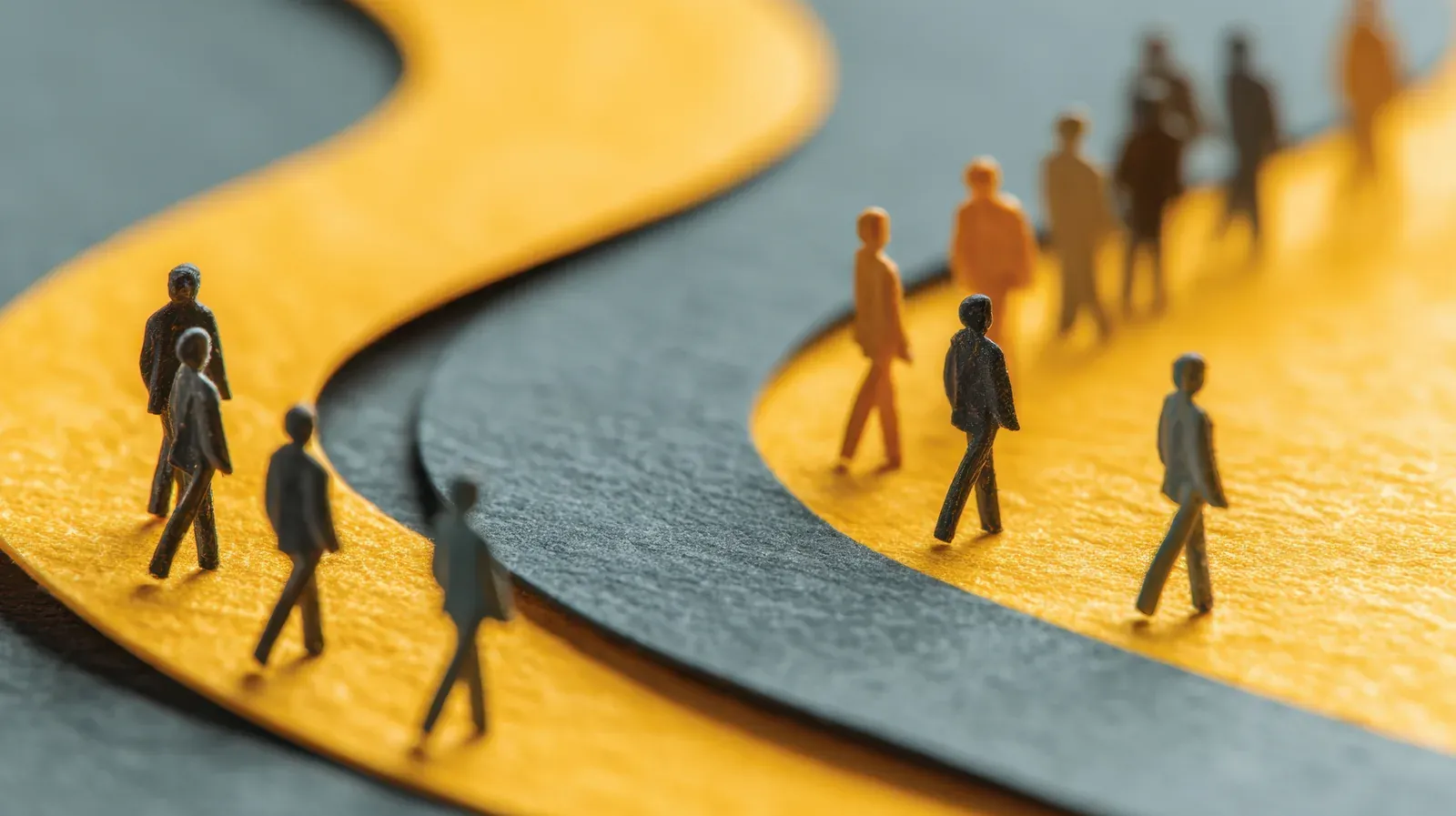 Small figures walking a winding path that forks and doubles back